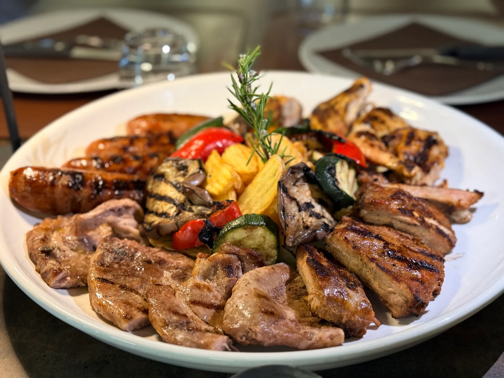 Grigliata mista di carne con salsicce, pollo, costine e verdure grigliate